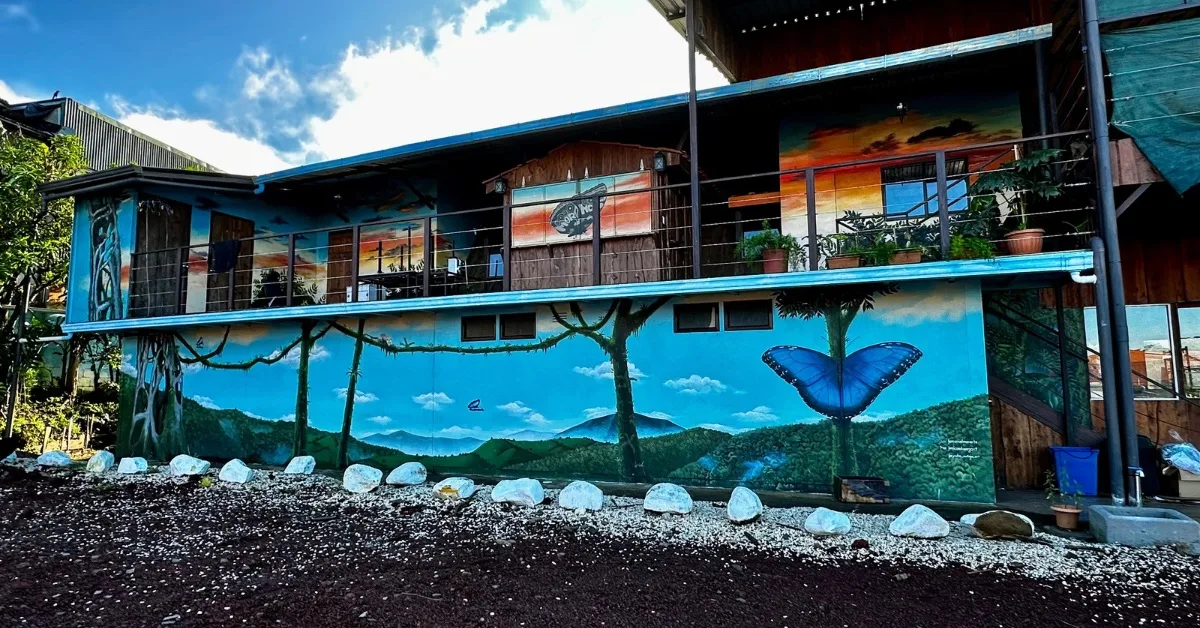 A restaurant exterior painted with illustrations of morpho butterflies which are bright blue.