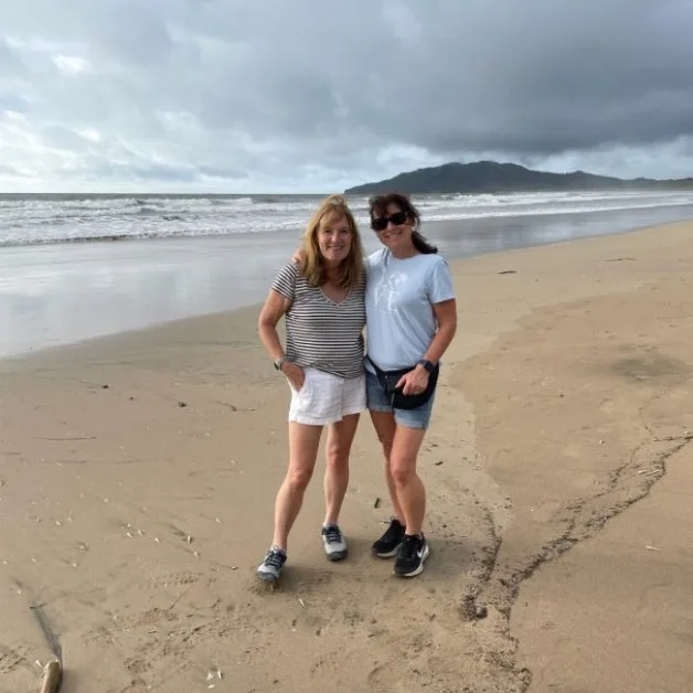 Two women walking on Playa Grande Beach in Costa Rica. It is a multi km stretch of sandy soft sand.