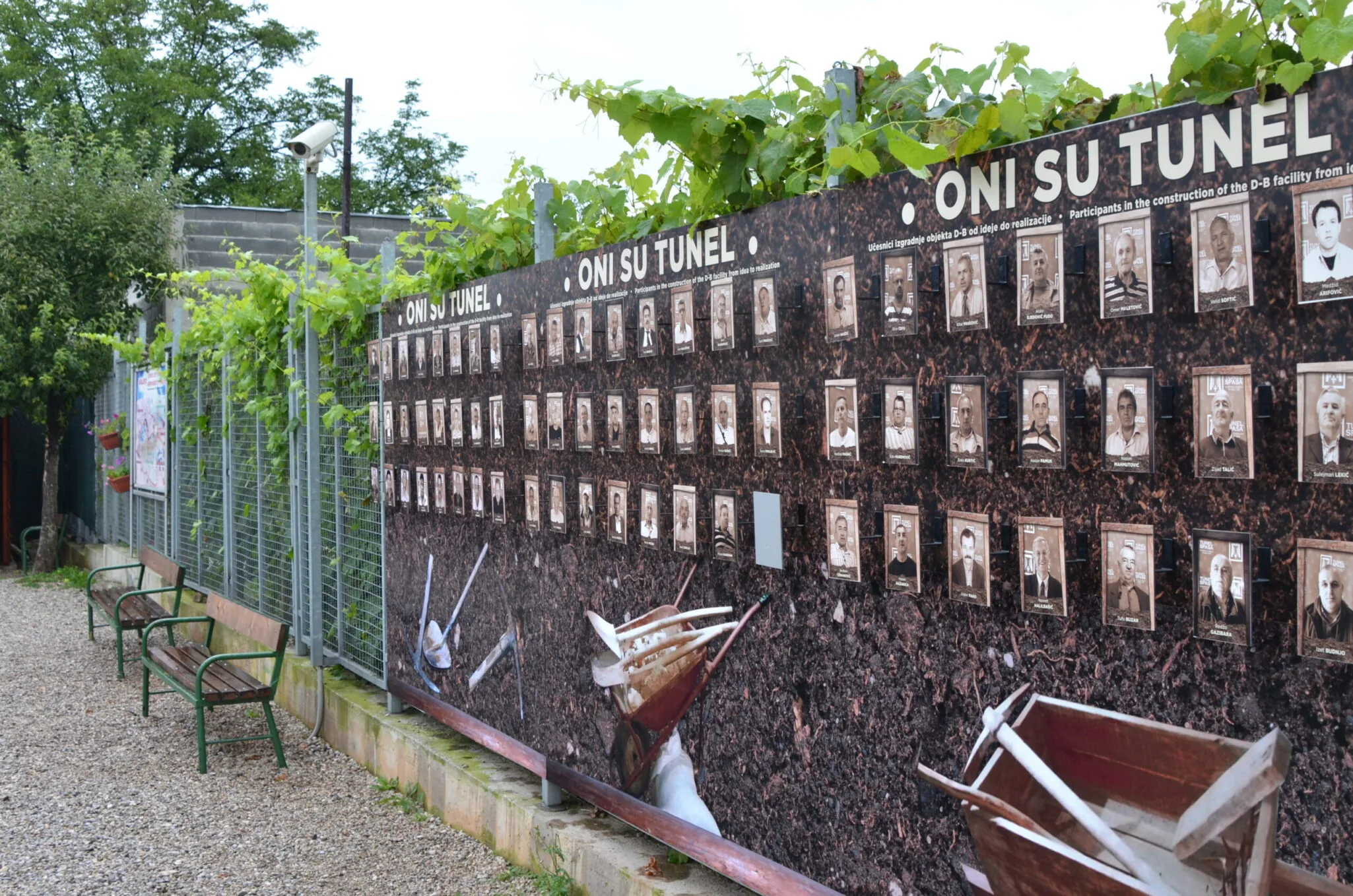 A memorial wall with photographs of people who dug the Sarajevo tunnel of hope.