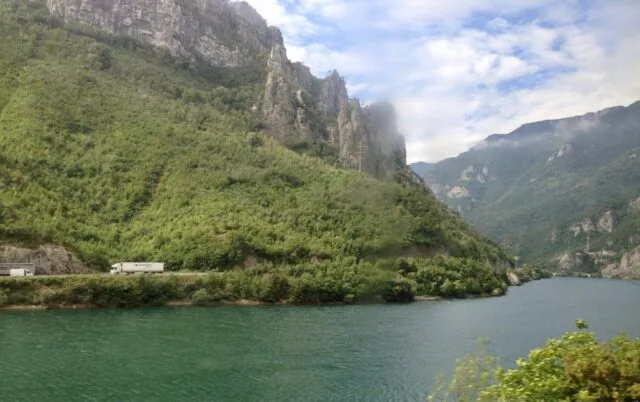 Forrested hillsides and rivers as seen from a train window in Bosnia