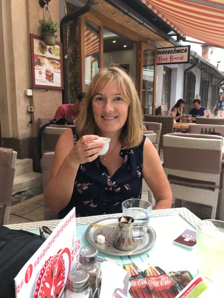 Tourist enjoying Bosnia coffee at a cafe in Sarajevo.