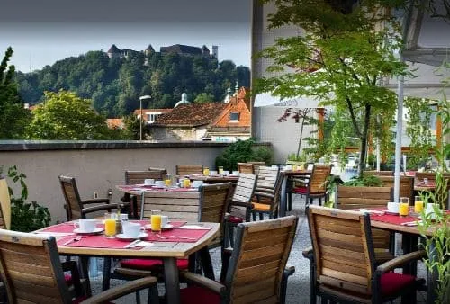 Tables are set for leisurely breakfast outdoors in Ljubljana Slovenia.