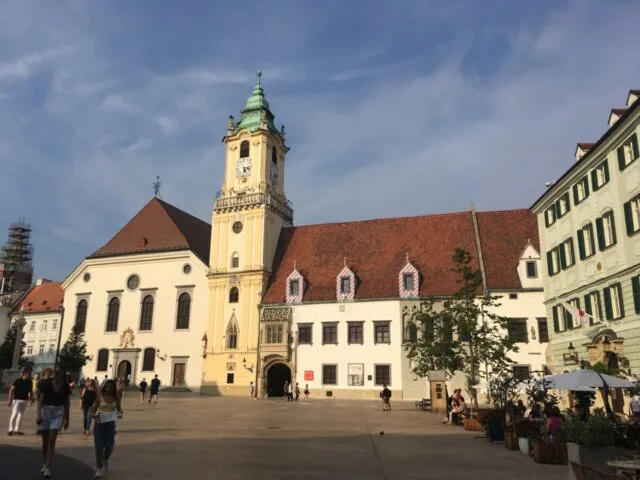 The main town hall is built from stone (light in colour) and with red tiled roof. Like many old European town halls it also has a tower attached to it which you can climb.