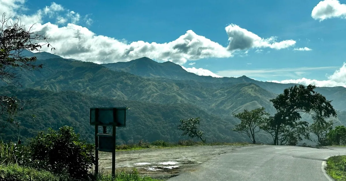 A rural mountain road twists sharply in Monteverde Costa Rica and requires careful driving.