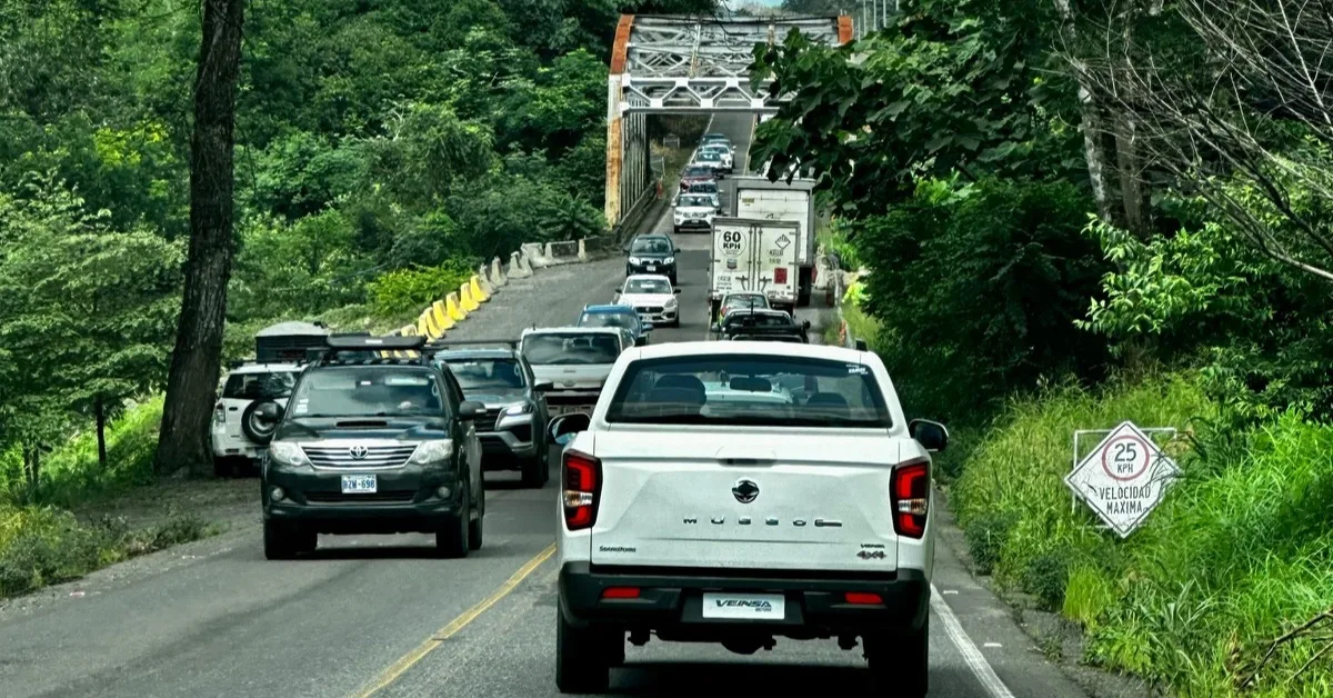 Stream of Cars  Driving in Costa Rica on a single lane route over a bridge.