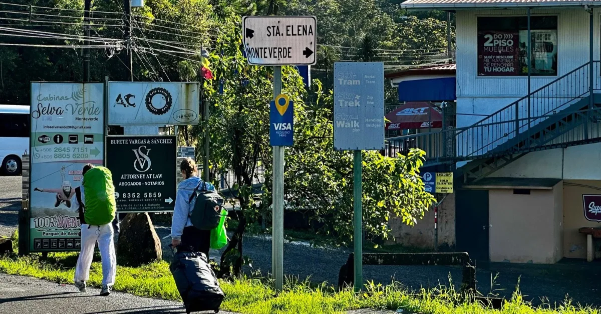 Visitors are walking with luggage on a road in Monteverde Costa Rica.