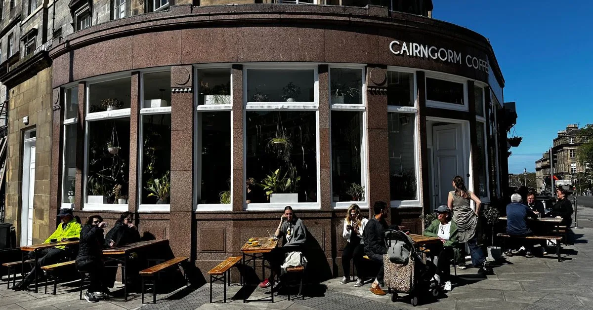 People are seated outside a coffee shop in Edinburgh.