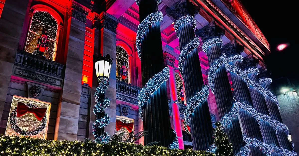 Festive lights twisted around round stone columns on the entrance of a building in George Street Edinburgh.