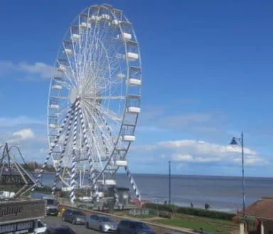 A ferris wheel coloured white is a main attraction at the seaside town of Felixstowe, England.