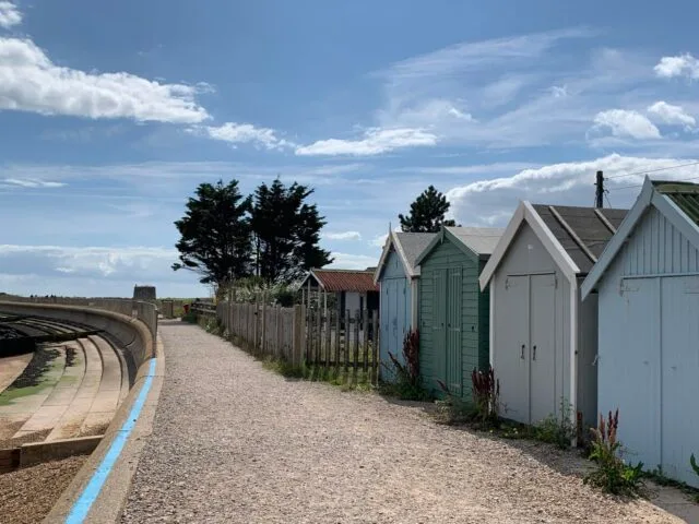 Beach huts and a pathway to the water.