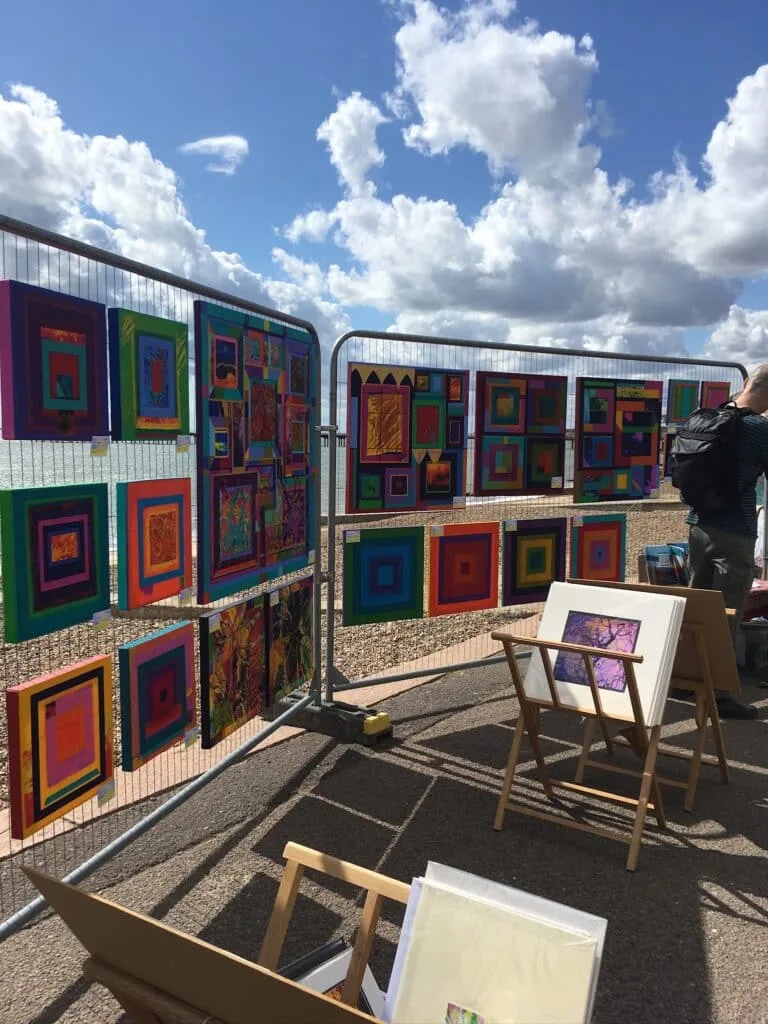 Art displayed on a beach promenade.