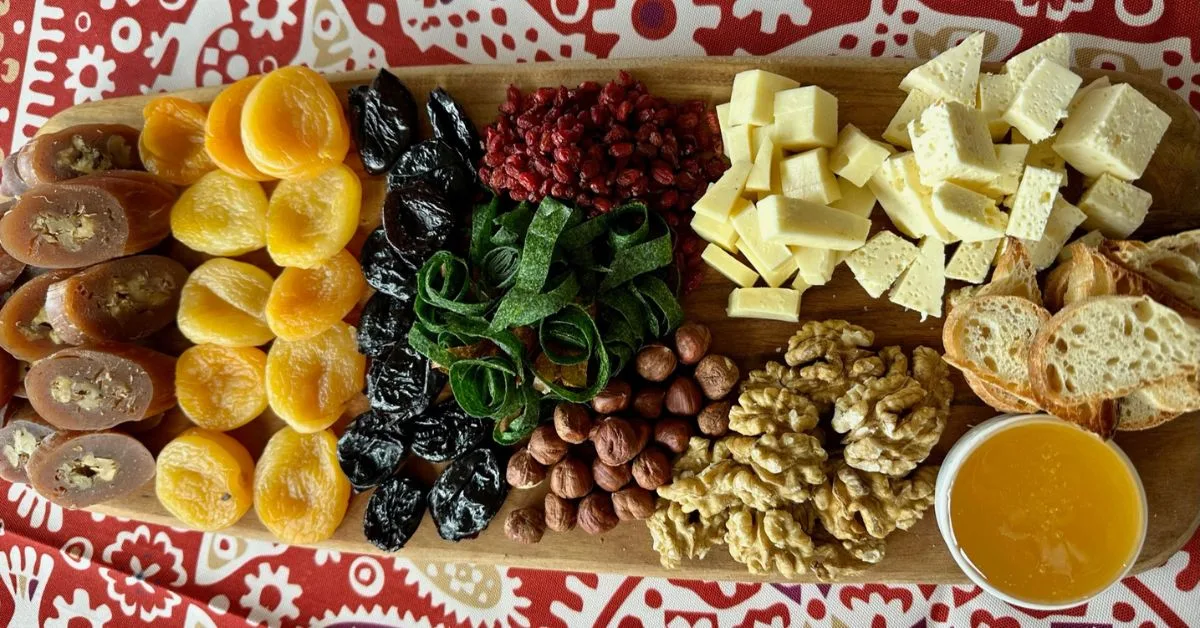 A traditional Georgian food board with bread, honey, cheese, local nuts, dried fruits and candies.