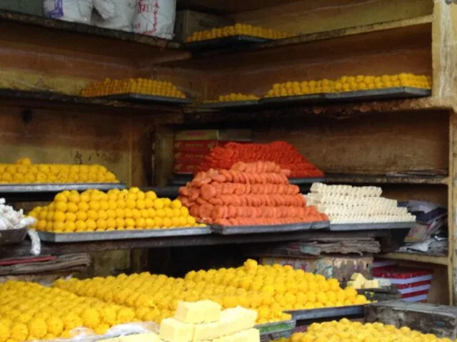 Street sweet treats in Jaipur market with yellow, orange and red cookies