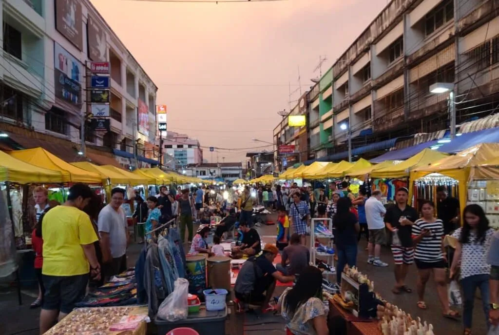 People are gathered in a street where a night market in taking place in Krabi, Thailand.
