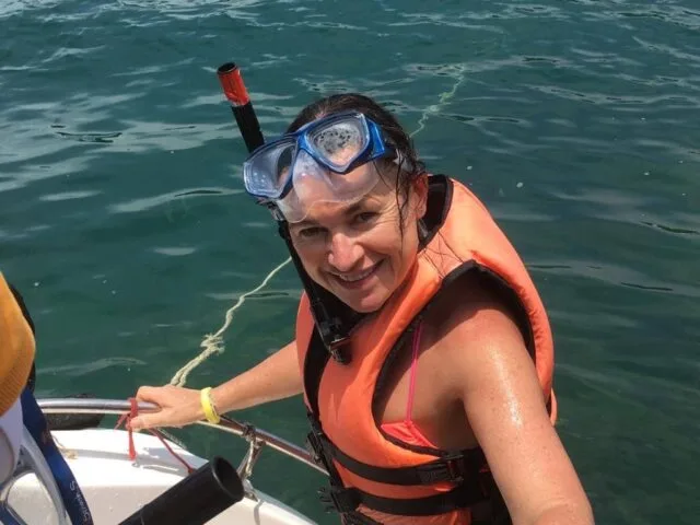Woman is about to go Snorkeling off a boat near Krabi, Thailand.