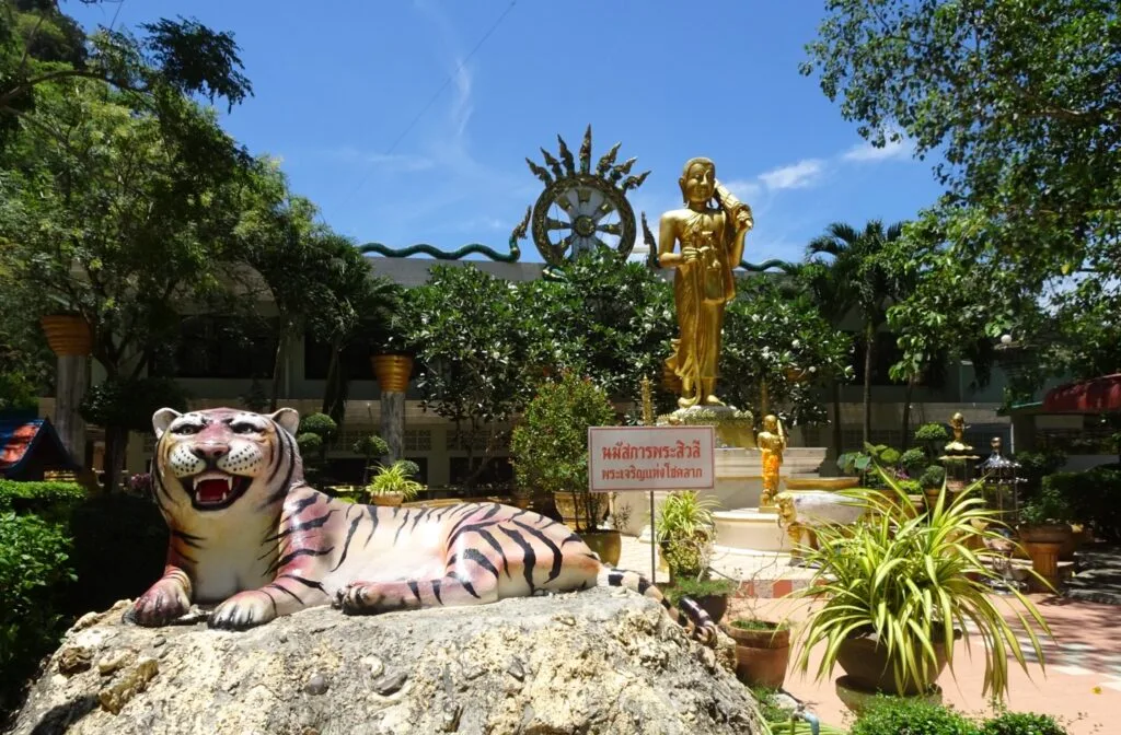 Tiger statue is at the entrance to a temple.