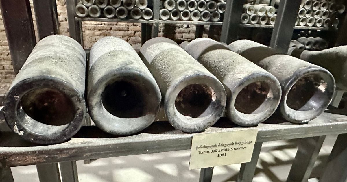 Vintage wine bottles in historic Kakheti wine cellar storage