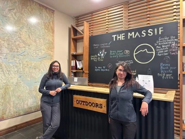 Women working at an activities desk in a hotel in Patagonia.