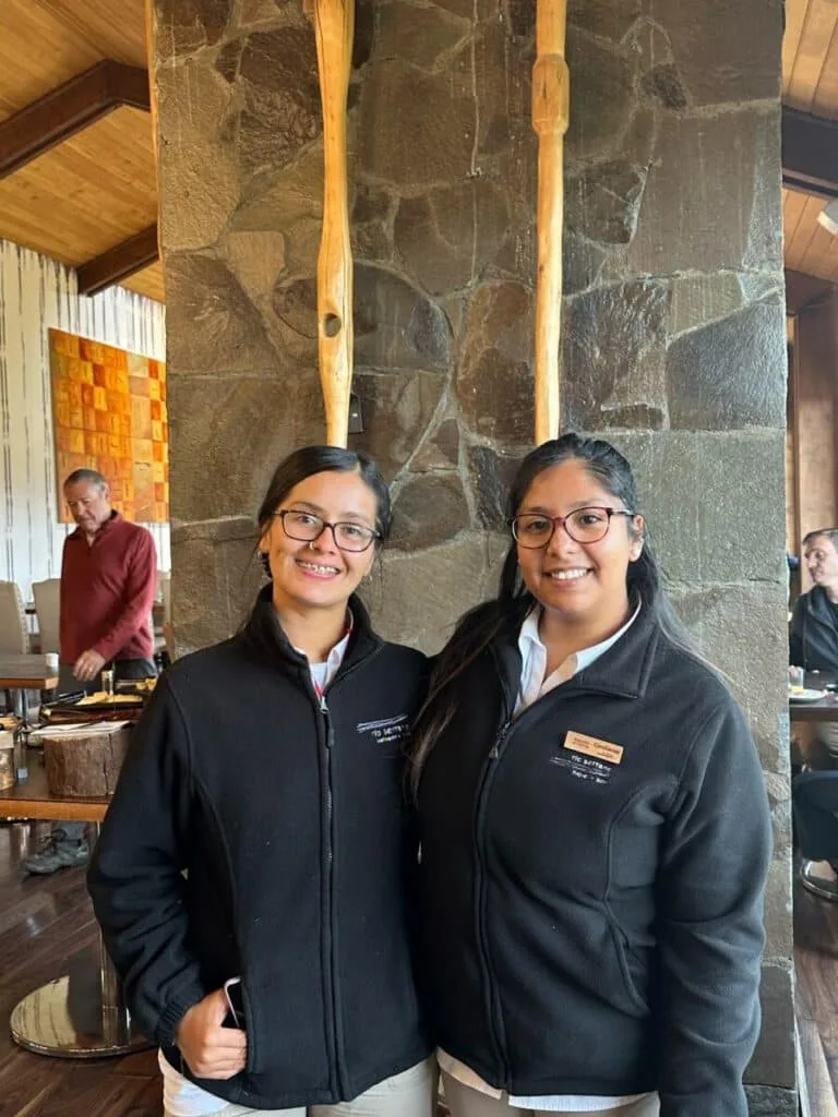 Two girls standing in a hotel restaurant where they work in Chile.