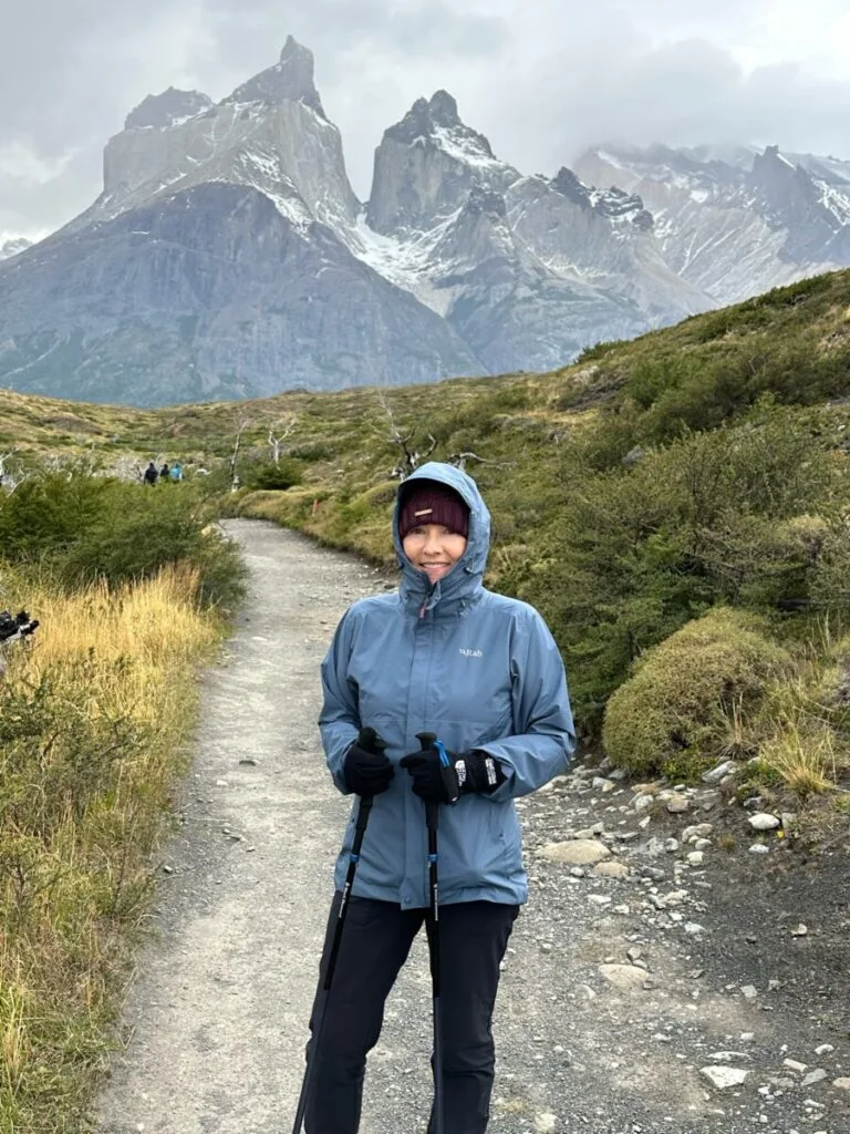 Woman is wrapped up warm as she hikes in Chile's Patagonian mountains.