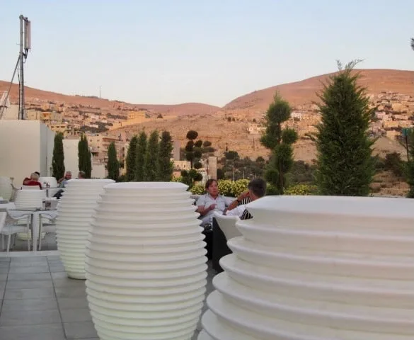 Large ceramic pots on a hotel terrace overlooking the desert of Jordan.