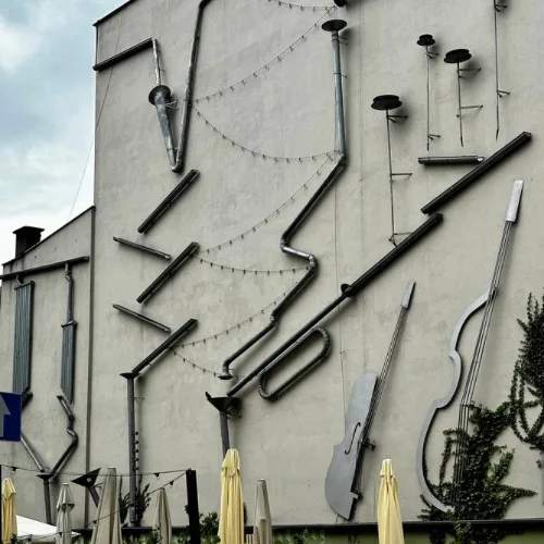 A wall covered with metal pipes that creates music when it rains.  An attraction in Poznan, Poland for visitors.