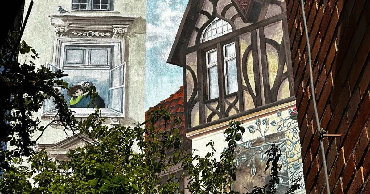 Mural in Jezyce of a child in the arms of a grandmother.