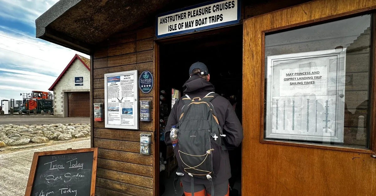 Visitor checking in at the wooden hut for an Isle of May boat trip in Anstruther.