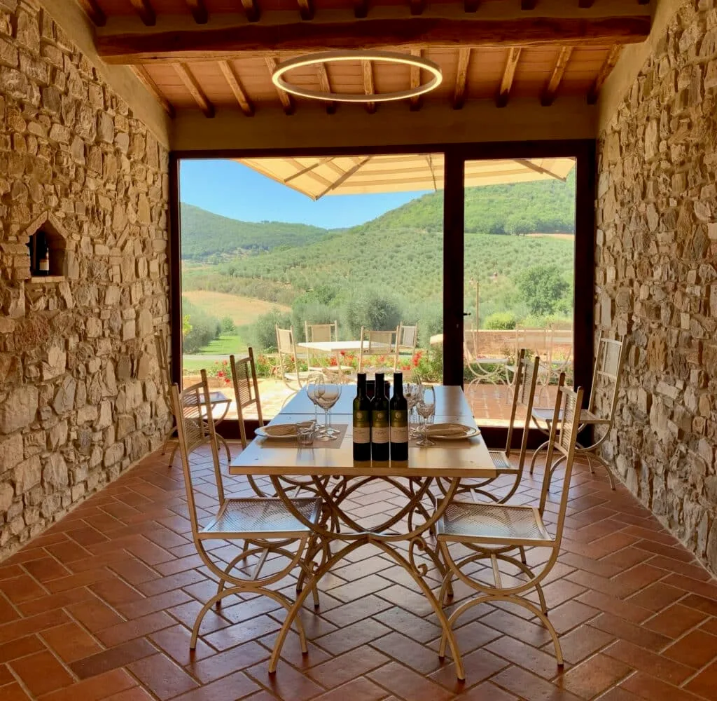 A dining area with views out over the Tuscan valleys.