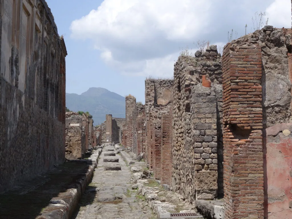 Ruins of homes with only partial bricks remaining in Pompeii Italy where an volcanic eruption covered the entire city.