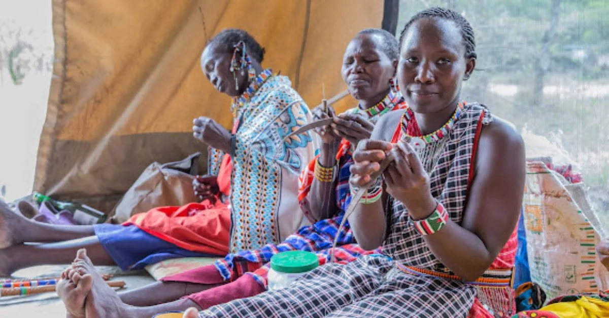 Three women in Masai Mara bead-making.