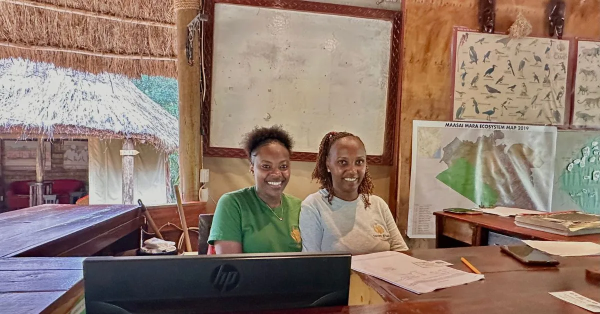 Two women at reception desk.