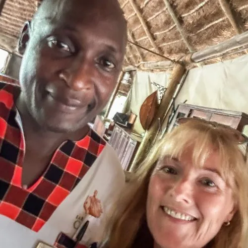 Guest and staff member at Karen  Blixen Camp smiling.