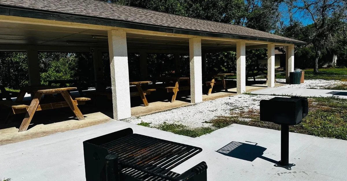 2 BBQ grills and covered picnic tables and benches.