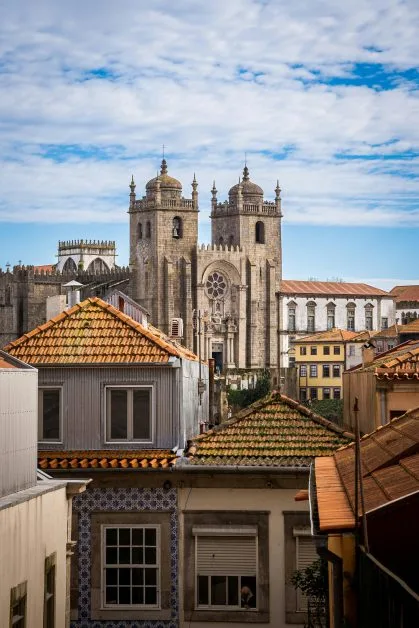 A built up area of a city with a cathedral and its towers rising up above other buildings.