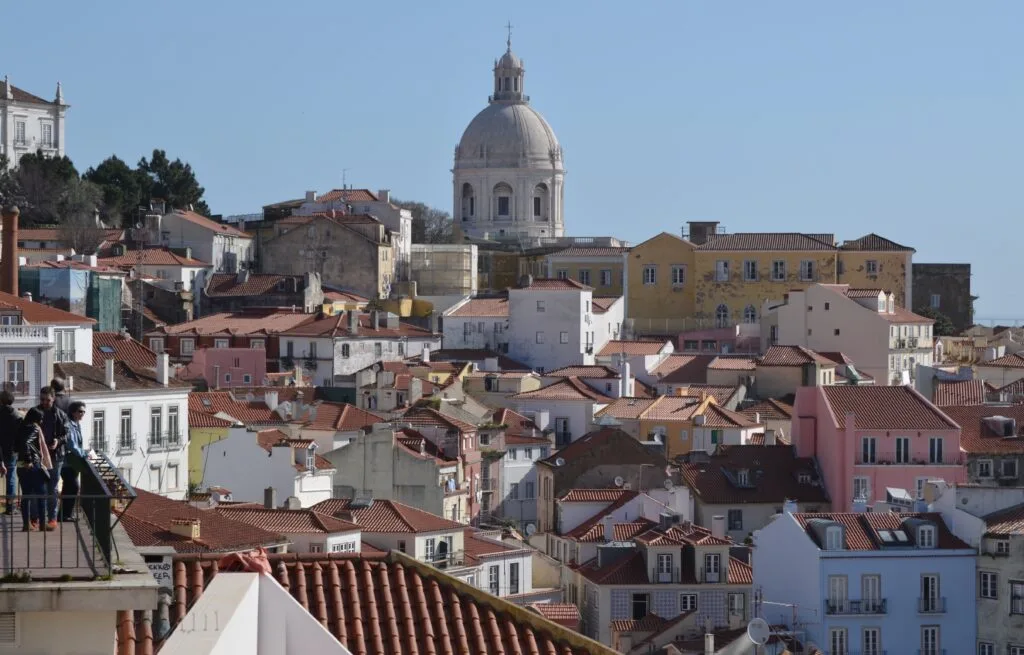 Views of the city of Lisbon with multi coloured buildings and rooftops.