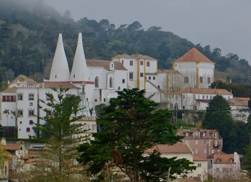 Sintra Village with a fairytale like towers and structures painted in white with yellow and orange contrast in roofs and wall corners.