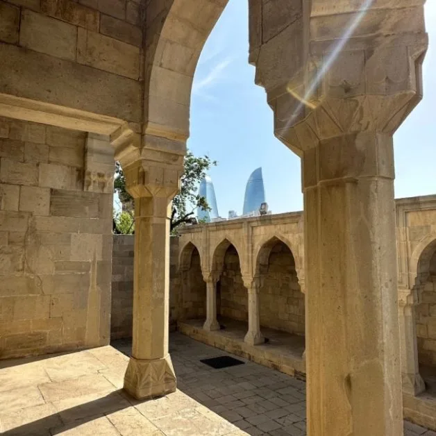 Pillars of the Shirvanshahs Palace in Baku with views over to the Flame Towers.