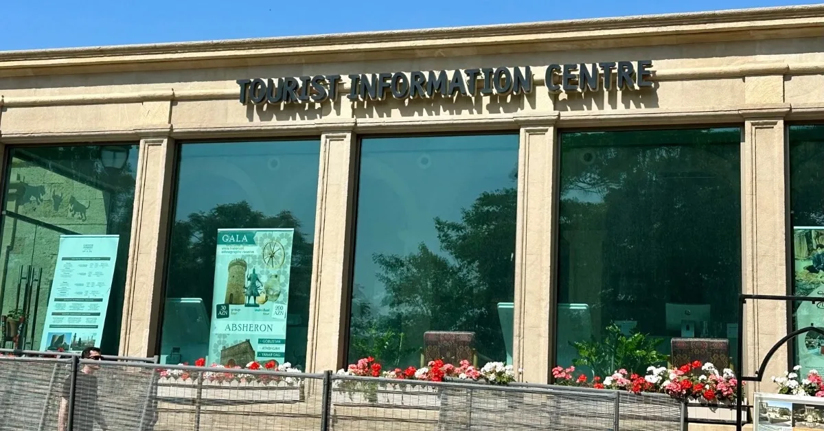 Tourist Information Centre in Baku with posters advertising Maiden Tower and other sights of the city.