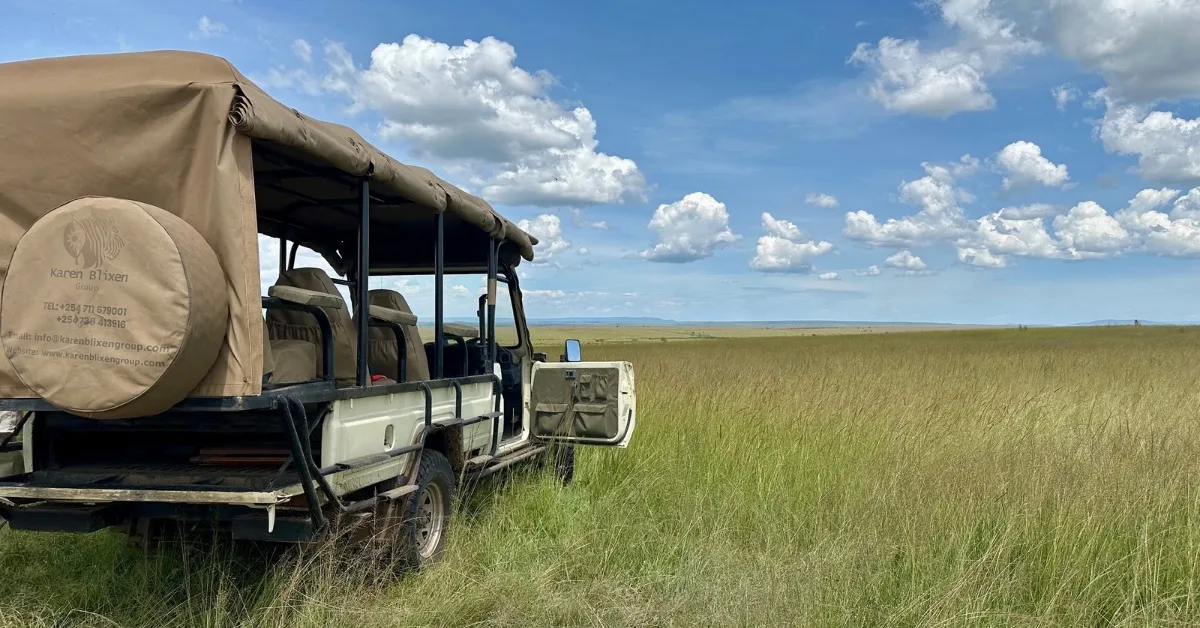 Safari Jeep in Masai Mara grasslands.