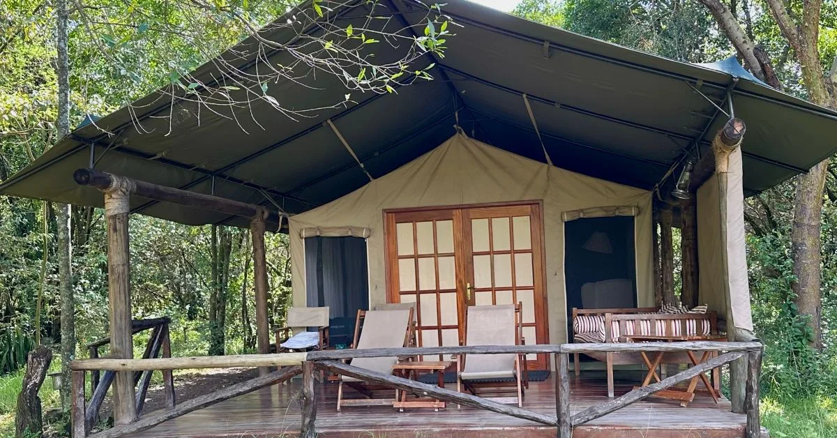 Safari tent with chairs and daybed on deck.