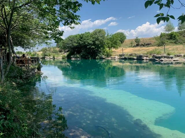Shades of torquoise waters in a tree lined river.