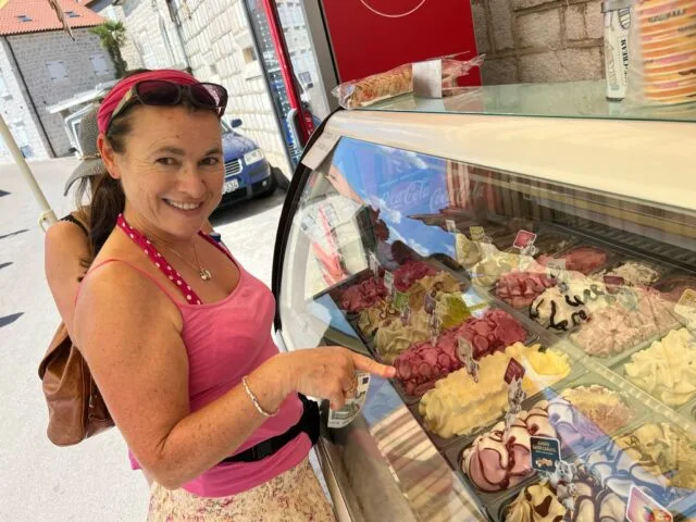 Women selecting ice cream from a street shop in Perast