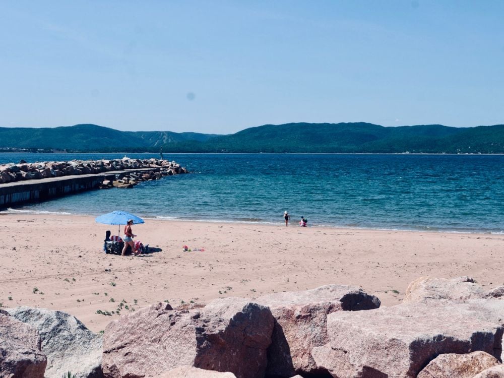 Scenic beach at Neil's Harbour with soft sand and clear water, Cape Breton