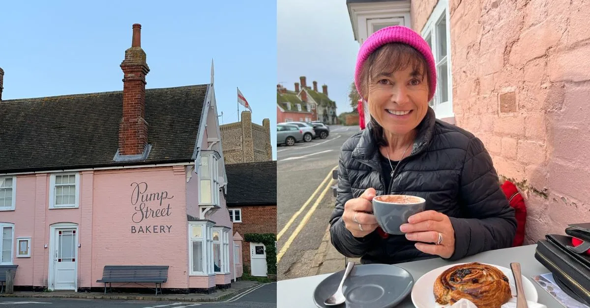 Pink Building with sign saying Bakery and woman sitting by the pink wall having a coffee and cake