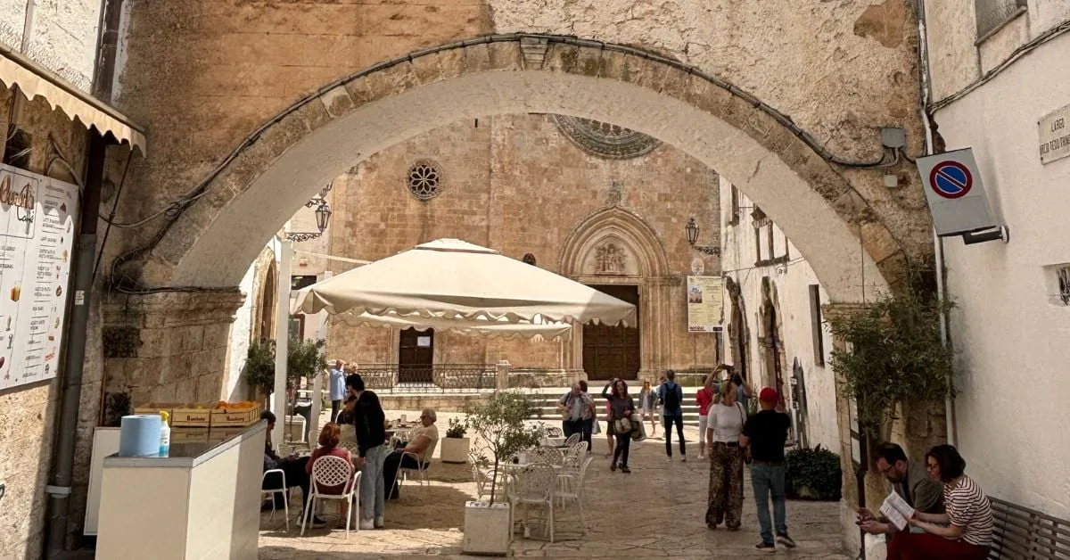 Cathedral archway entrance in Ostuni, Puglia — whitewashed baroque architecture