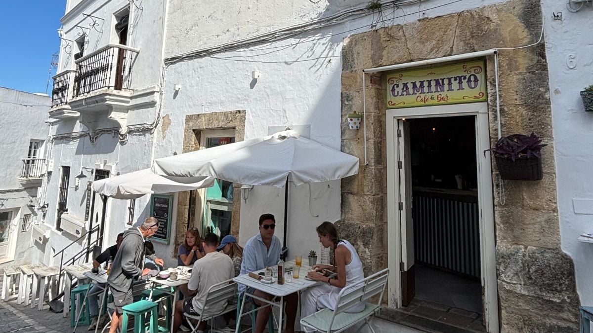 Outdoor street cafe dining in Vejer de la Frontera with tables on a cobbled lane