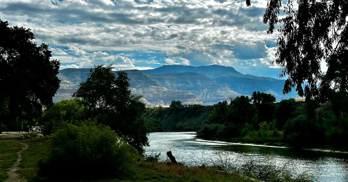 Walking path at Riverbend Park next to the river. Views of Grand Mesa as you walk.