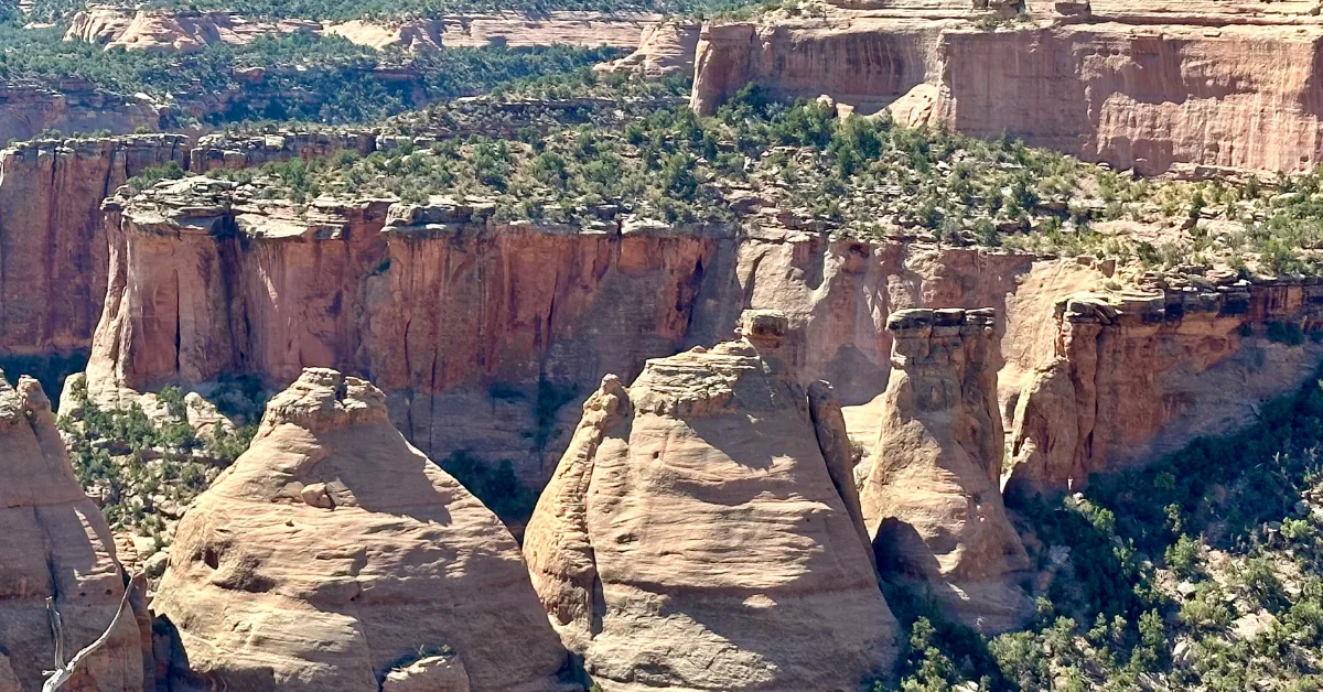 Rocks called coke ovens due to their similar shape tower above the valley at National Monument Park, Colorado.