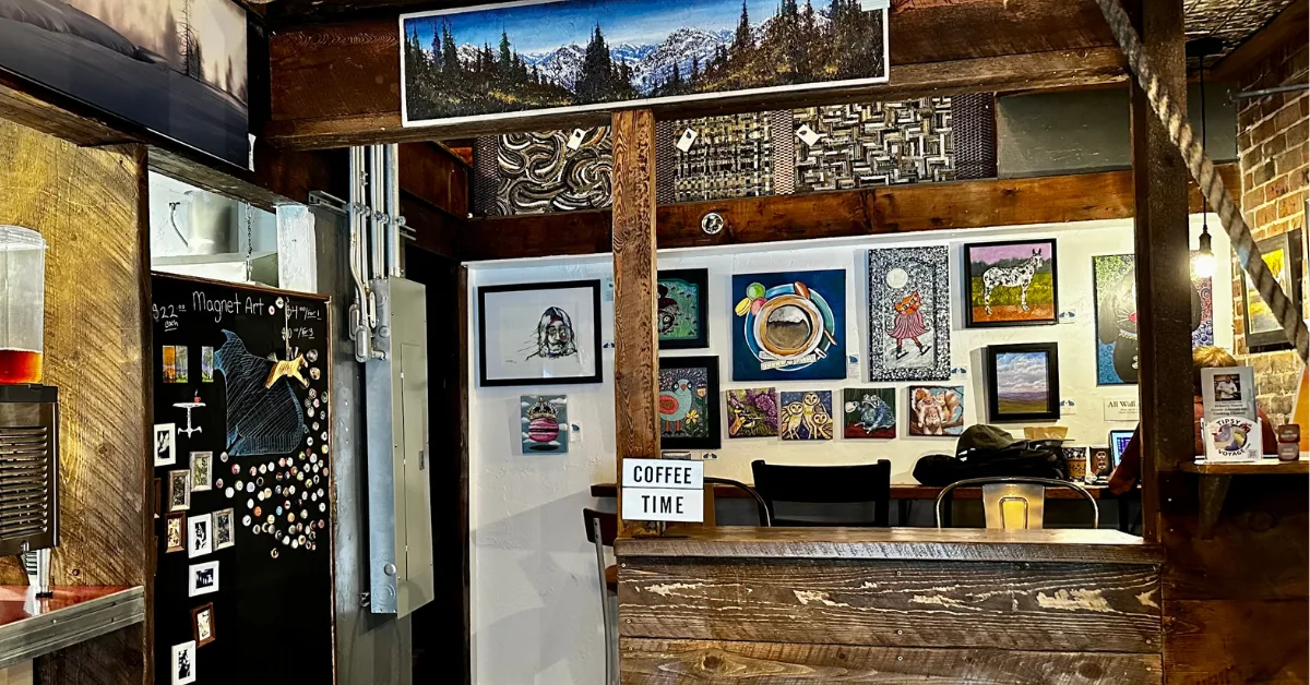 A coffee shop interior  filled with artwork.